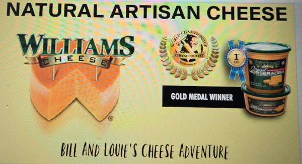 Bill and Louie's Cheese Adventure sign featuring Williams Cheese, award medals, and tubs of cheese